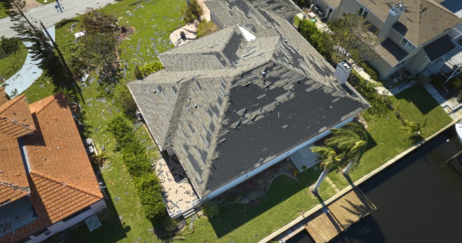 Hurricane destroyed house roof in Florida residential area.